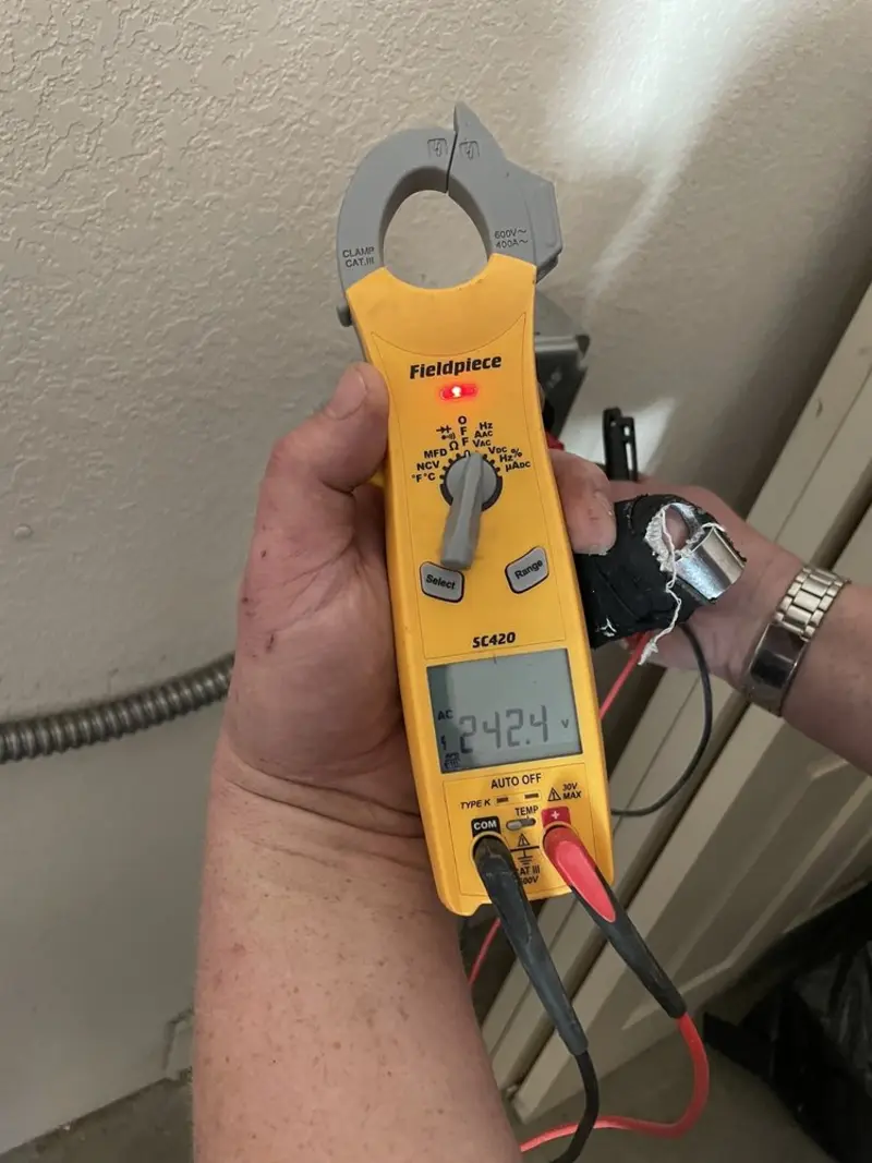 Voltage testing with clamp meter during Recessed Lighting Installation in Springville